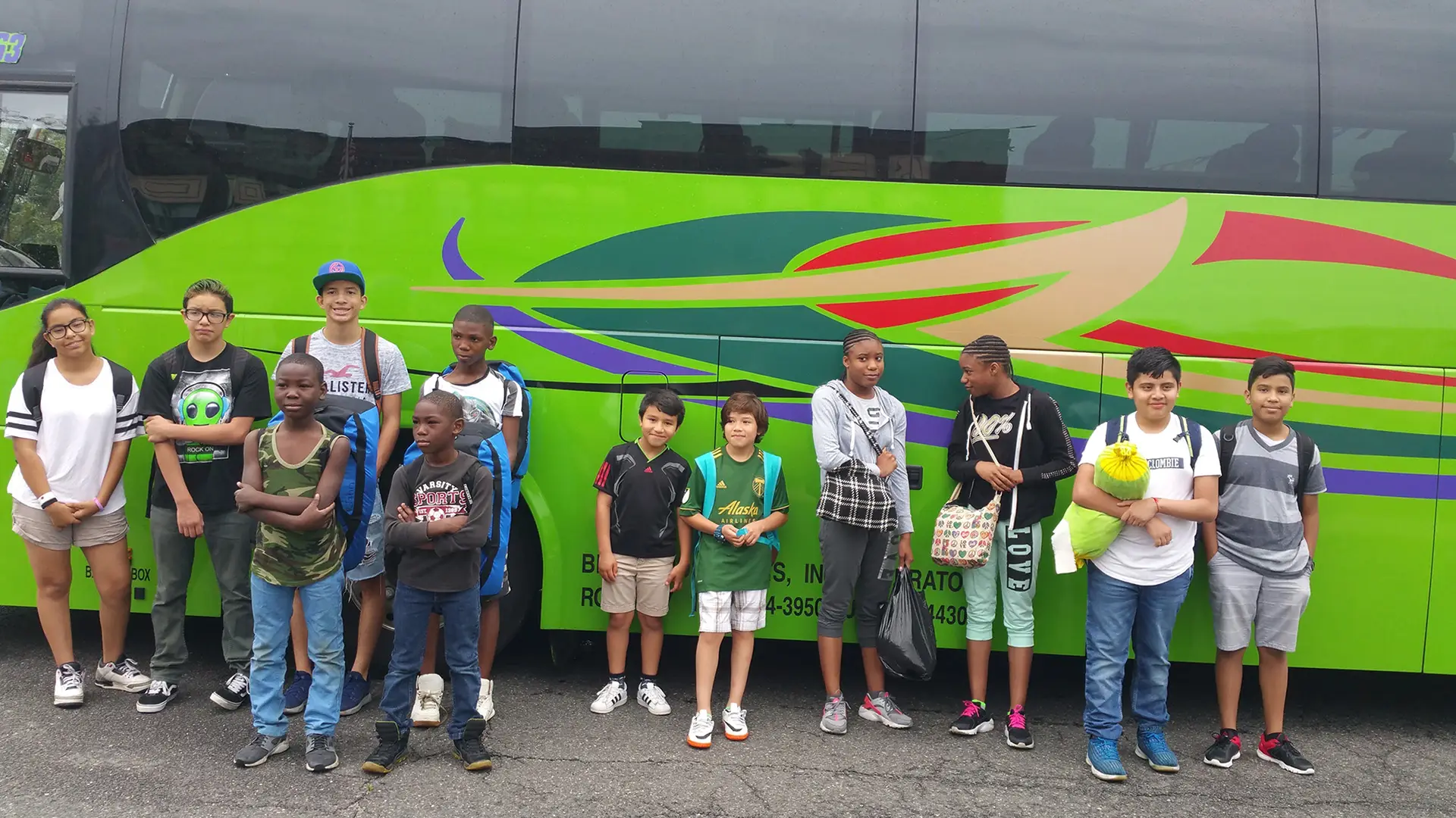 Children waiting outside their bus.